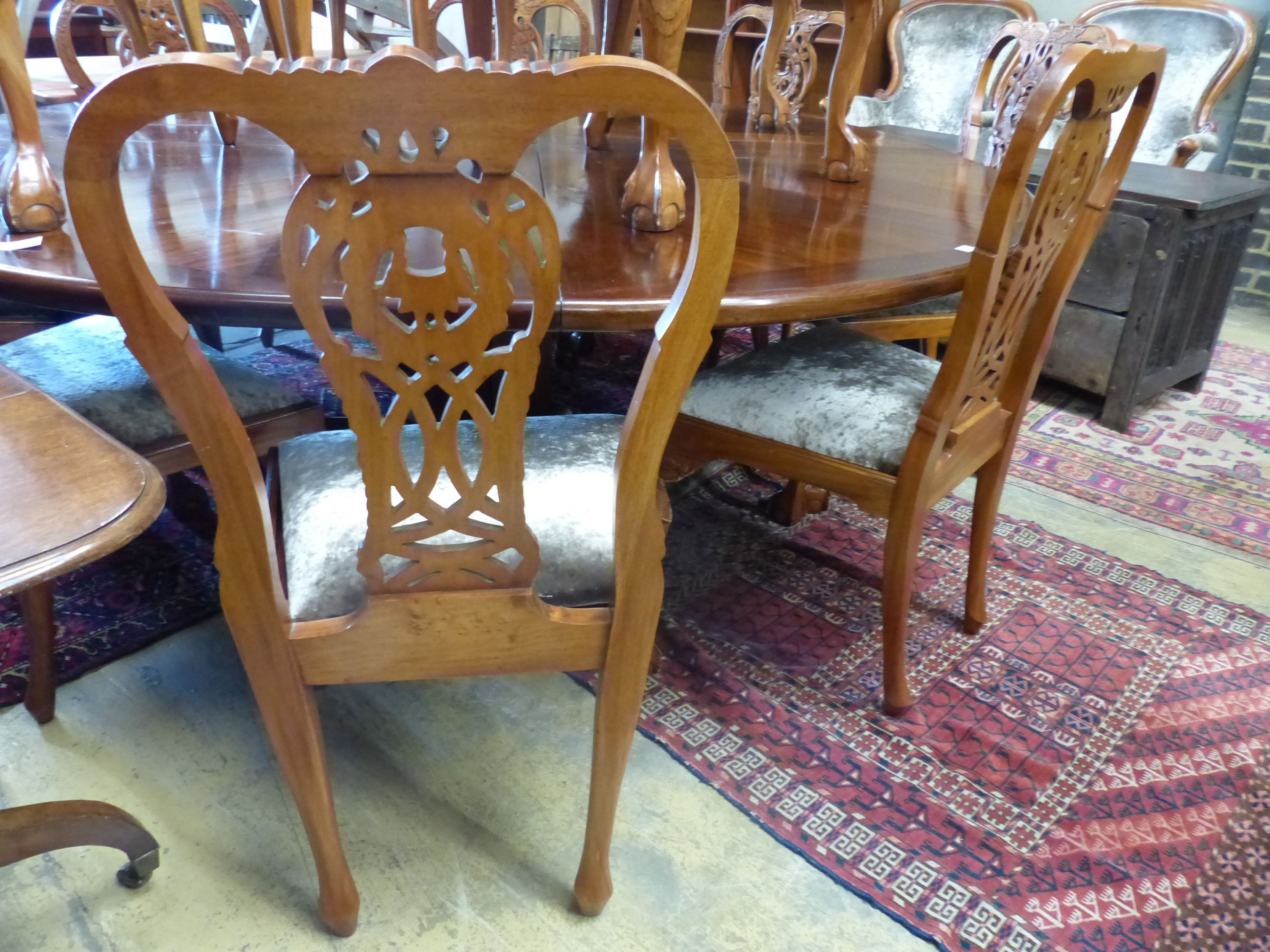 A set of twelve Chippendale style mahogany dining chairs, four with arms